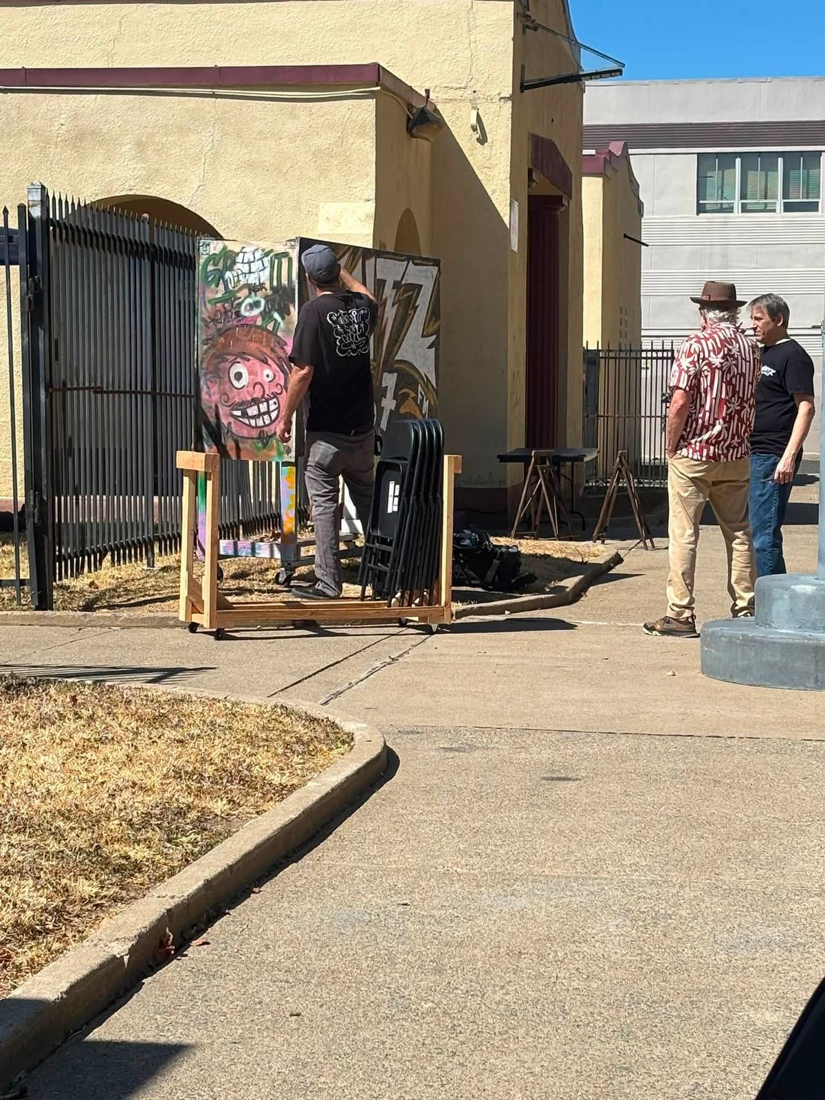 Painted panels by local artists set up beside the school's side gate