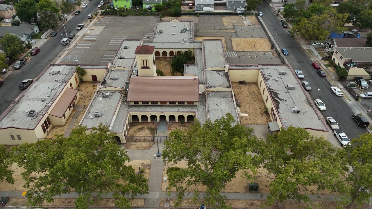 Drone view of the school campus and its tree-lined frontage